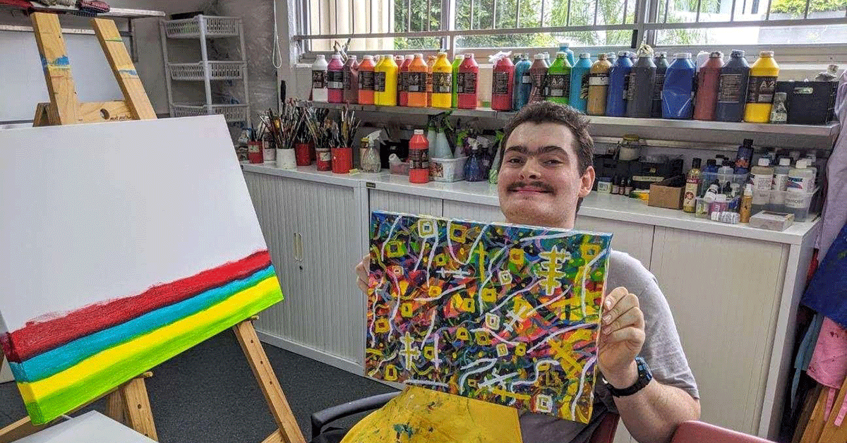 Young man showcasing painting