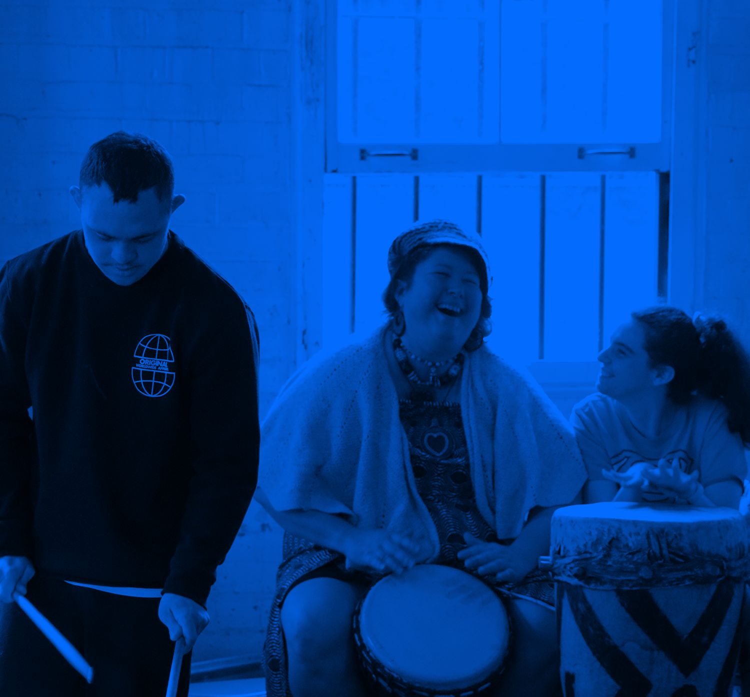 Blue washed image of three people drumming