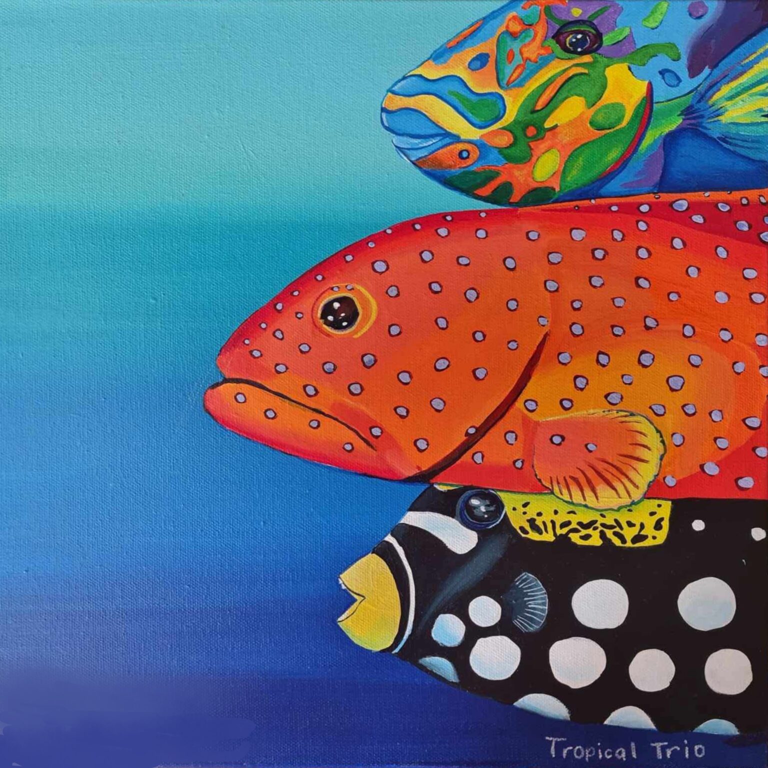 A vibrant painting of three tropical fish stacked diagonally across a blue background. Each fish is brightly coloured with distinctive patterns, including dots and contrasting markings.